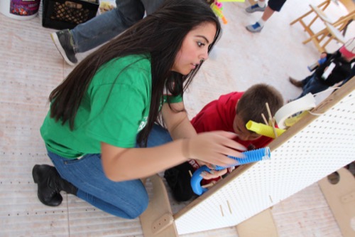 Lawrence Hall of Science Teen Volunteer Engages a Younger Child